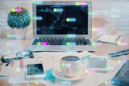 Double exposure of table with computer on background and data theme hologram. Data technology...