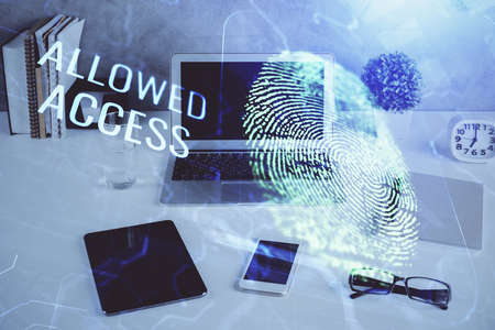 Computer on desktop in office with finger print drawing. Double exposure. Concept of business data...