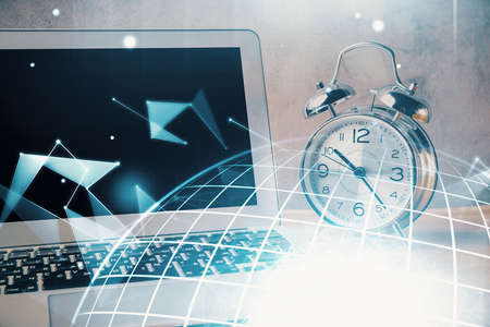 Double exposure of desktop with computer and world map hologram. International data network concept.