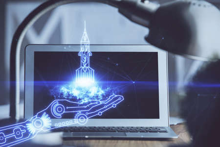 Desktop computer background in office and start up theme hologram drawing. Double exposure. Startup...