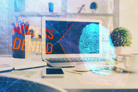Computer on desktop in office with finger print drawing. Double exposure. Concept of business data...