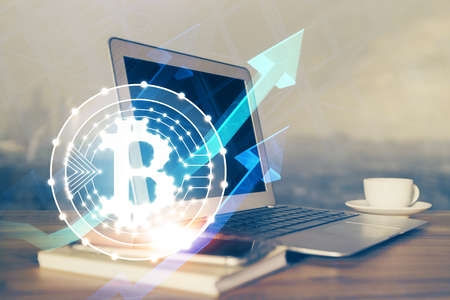 Multi exposure of blockchain theme hologram and table with computer background. Concept of bitcoin crypto currency.の写真素材