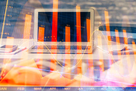 Financial graph colorful drawing and table with computer on background. Multi exposure. Concept of...