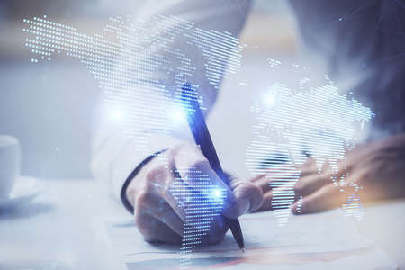 Mans hands working with notes background. Social networking concept. Crowd sourcing. Global business. Multi exposure.の写真素材