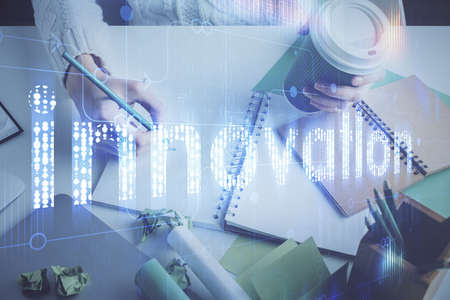 Double exposure of hands making notes background with technology and digital coding huds. Data learning concept.の写真素材