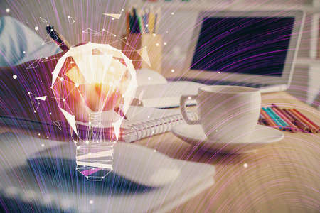 Drawing bulb over womans hands taking notes background. Concept of idea. Double exposureの写真素材