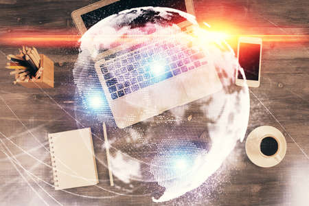 Business theme hologram drawings over computer on the desktop background. Top view. Multi exposure....