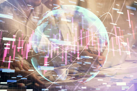 Multi exposure of man and woman working together and financial chart hologram. Business concept. Computer background.の写真素材