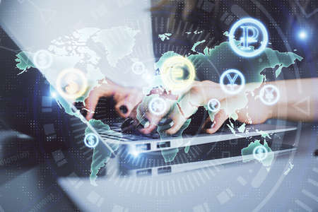 Double exposure of woman hands typing on computer and forex chart hologram drawing. Stock market invest concept.の写真素材
