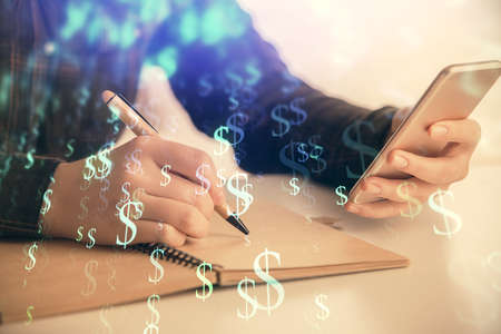 Double exposure of forex graph sketch hologram and woman holding and using a mobile device. Stock market concept.の写真素材