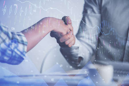 Double exposure of forex graph hologram and handshake of two men. Stock market concept.の写真素材