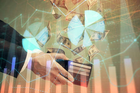 Multi exposure of financial graph drawing hologram and USA dollars bills and man hands. Analysis...