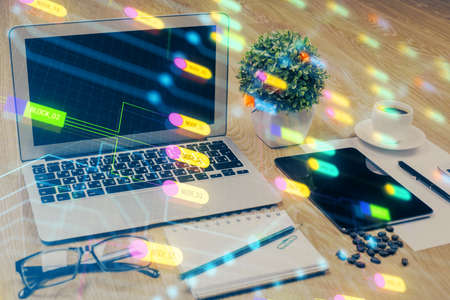 Double exposure of table with computer on background and data theme drawing. Concept of innovation.の写真素材
