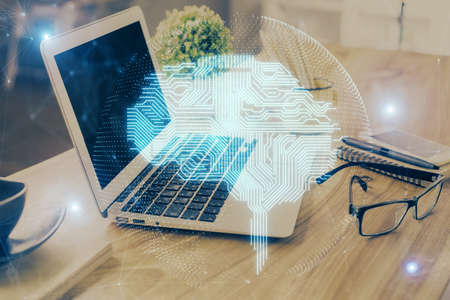 Double exposure of desktop with computer and brain drawing hologram. Artificial intelligence...
