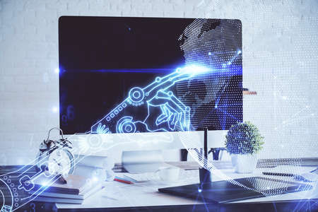 Computer on desktop in office with technology theme hologram. Double exposure. Tech concept.の写真素材