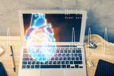 Desktop computer background and heart drawing. Double exposure. Medical study and healthcare concept.の写真素材