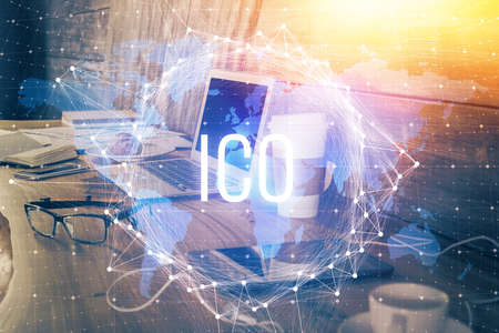 Double exposure of blockchain theme hologram and table with computer background. Concept of bitcoin crypto currency.の写真素材