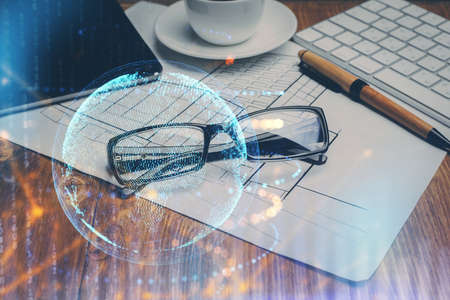 Map hologram with glasses on the table background. Concept of globalization. Double exposure.の写真素材