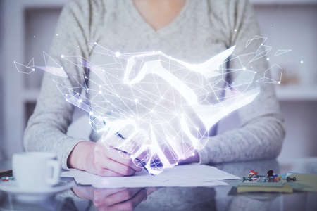 Handshake drawing over hands taking notes background. Concept of success. Double exposureの写真素材