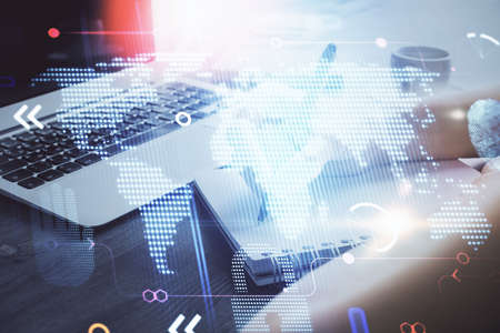Double exposure of hands making notes with world map hologram and data theme icons. Concept of...
