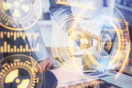 Technology theme hologram with man working on computer on background. High tech concept. Multi exposure.の写真素材