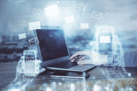 Envelop holograms with businessman working on computer on background. E-mail concept. Multi...