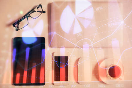 Multi exposure of financial chart hologram over desktop with phone. Top view. Mobile trade platform concept.の写真素材