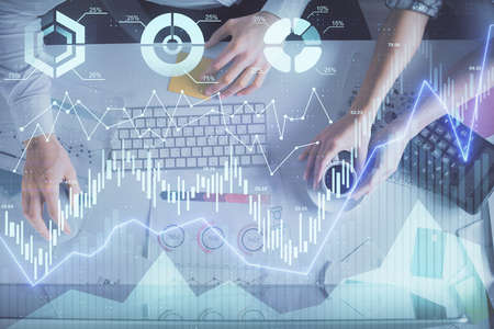 Double exposure of man and woman working together and financial chart hologram drawing. market...