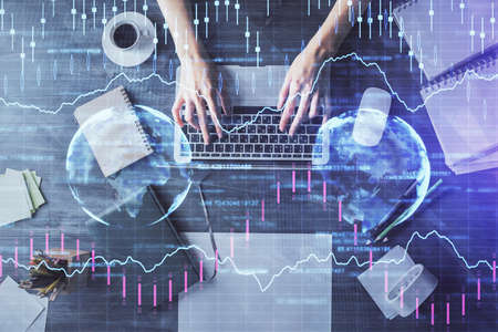 Multi exposure of woman hands working on computer and forex chart hologram drawing. Top View....