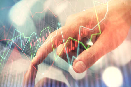 Multi exposure of mans hands holding and using a phone and financial chart drawing. Market analysis...