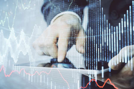 Multi exposure of mans hands holding and using a phone and financial chart drawing. Market analysis...
