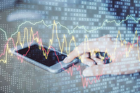 Double exposure of forex chart sketch hologram and woman holding and using a mobile device....