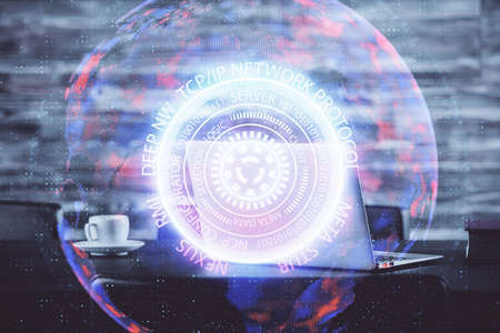 Computer on desktop in office with technology theme hologram. Double exposure. Tech concept.の写真素材