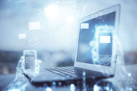 Desktop computer background in office and flying envelops hologram drawing. Double exposure....