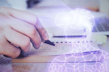 Abstract man wearing augmented reality headsets computer work with writing human background. AR concept. Double exposure.の写真素材