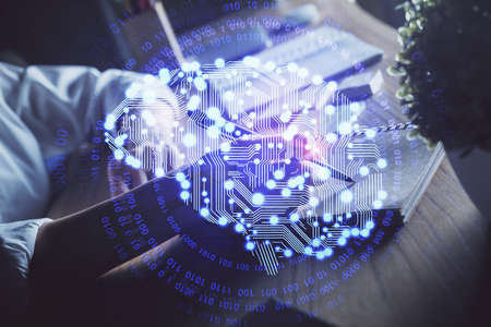Multi exposure of writing hand on background with brain hologram. Concept of self learning.