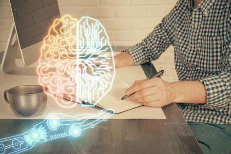 Man typing on keyboard background with brain hologram. Concept of big Data. Double exposure.