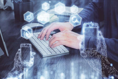 Technology theme hologram with man working on computer on background. High tech concept. Multi exposure.の写真素材