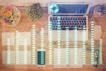 Stock market graph and top view computer on the table background. Multi exposure. Concept of...
