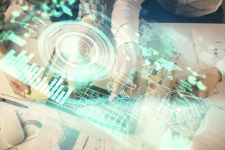 Double exposure of man and woman working together and business theme hologram drawing. Computer...
