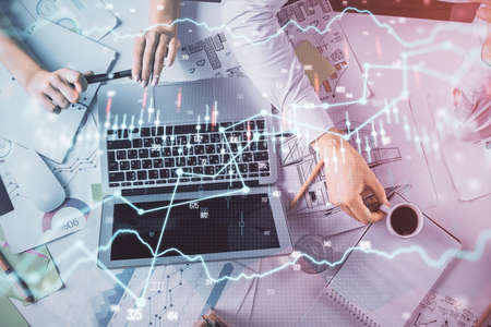 Double exposure of man and woman working together and financial graph hologram. Business concept....