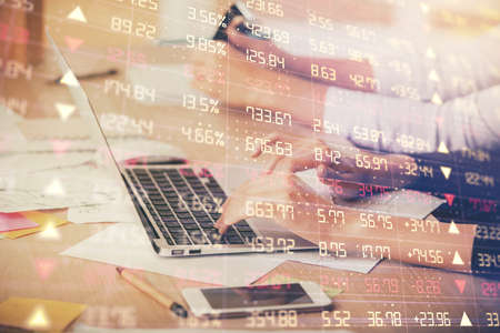Multi exposure of woman hands typing on computer and financial chart hologram drawing. Stock market...