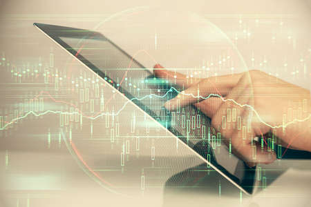 Multi exposure of mans hands holding and using a digital phone and forex graph drawing. Financial market concept.の写真素材