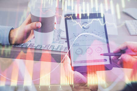 Double exposure of mans hands holding and using a phone and financial chart drawing. Market analysis...