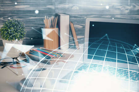 Double exposure of desktop with computer and world map hologram. International data network concept.