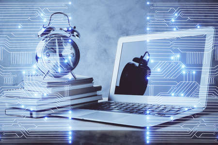 Computer on desktop in office with technology theme hologram. Double exposure. Tech concept.