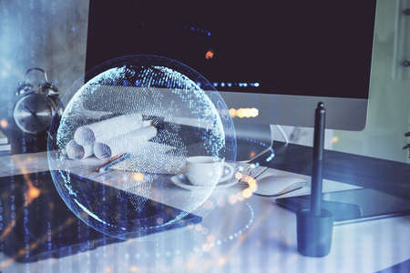 Multi exposure of table with computer and world map hologram. International data network concept.