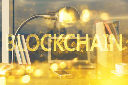 Double exposure of blockchain theme hologram and table with computer background. Concept of bitcoin crypto currency.の写真素材