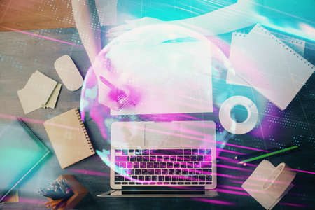 Tech theme hologram over womans hands taking notes background. Concept of hightech. Double exposureの写真素材
