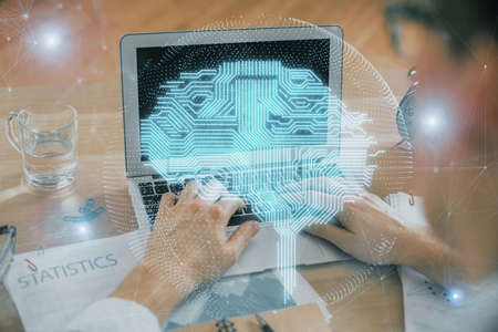 Man typing on keyboard background with brain hologram. Concept of big Data.